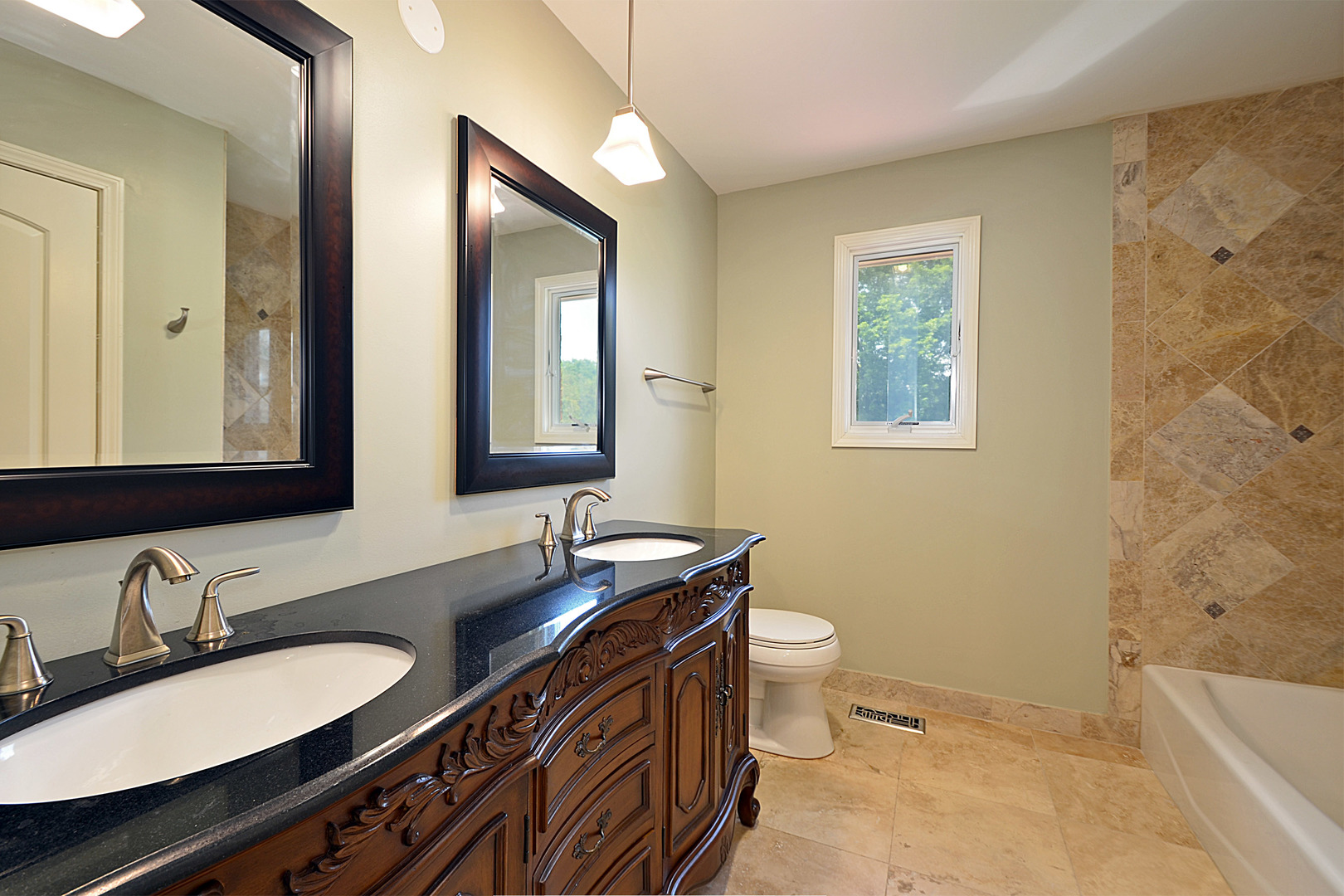 1435 Dunheath Drive Inverness, IL 60010 - Photo 17 of 27 a bathroom with a double vanity sink toilet and mirror