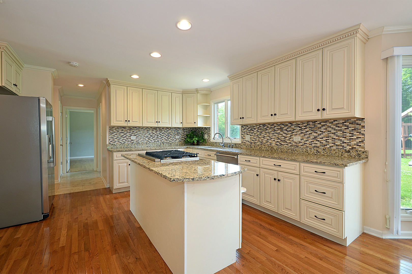 1435 Dunheath Drive Inverness, IL 60010 - Photo 3 of 27 a kitchen with granite countertop white cabinets and white appliances