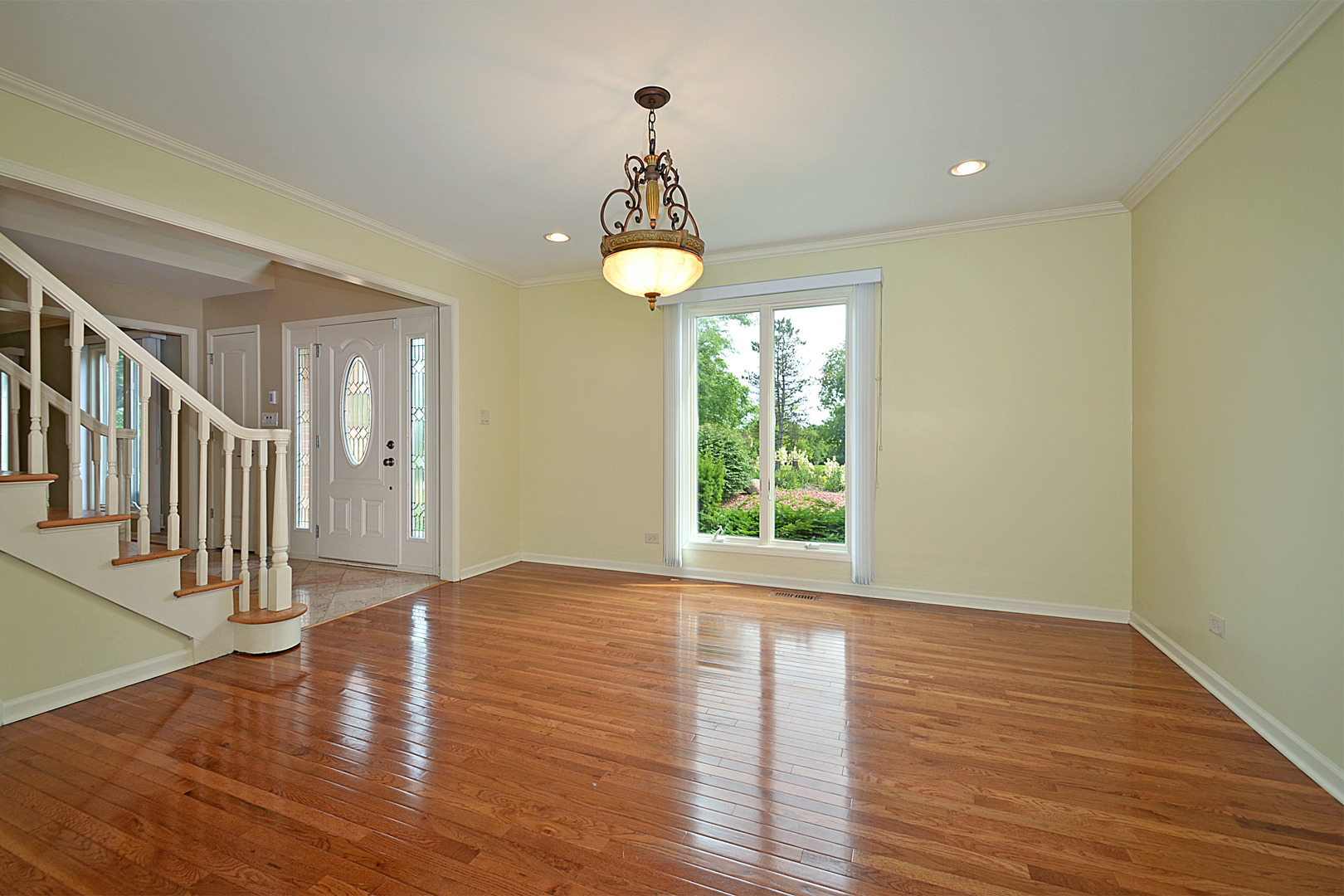 1435 Dunheath Drive Inverness, IL 60010 - Photo 8 of 27 a view of an entryway with wooden floor windows and a chandelier