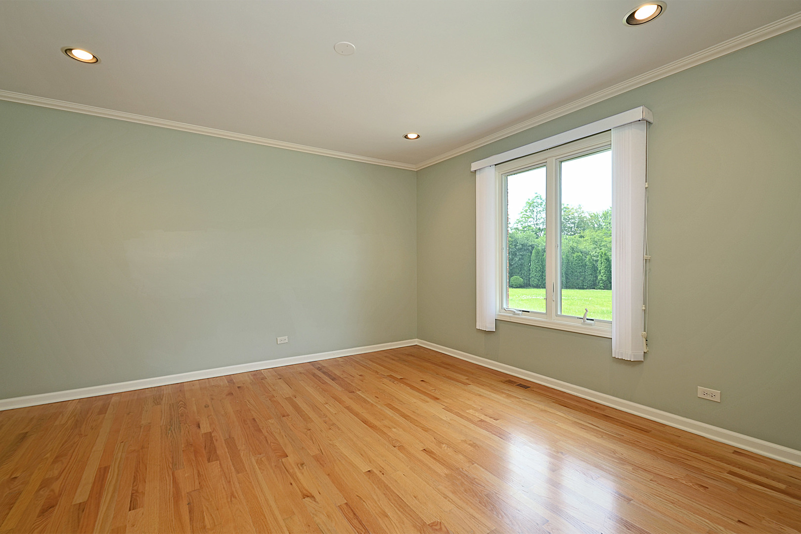 1435 Dunheath Drive Inverness, IL 60010 - Photo 9 of 27 a view of empty room with wooden floor and fan