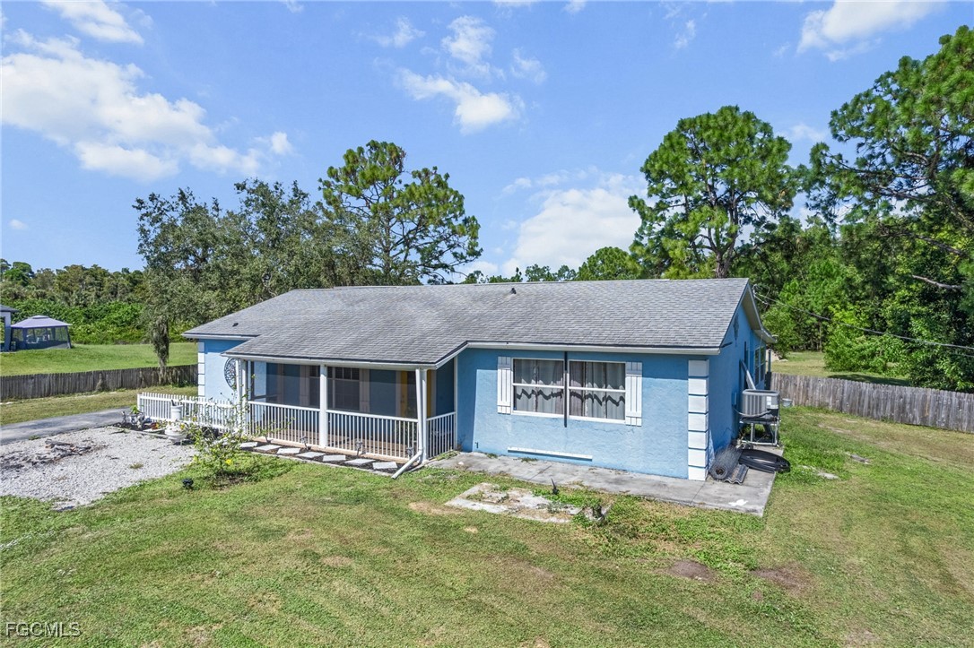 a house with huge green field in front of it
