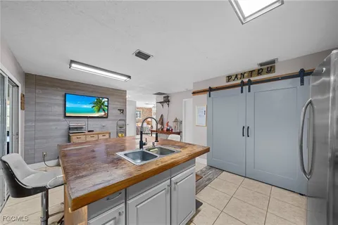 a kitchen with stainless steel appliances granite countertop a sink and a refrigerator