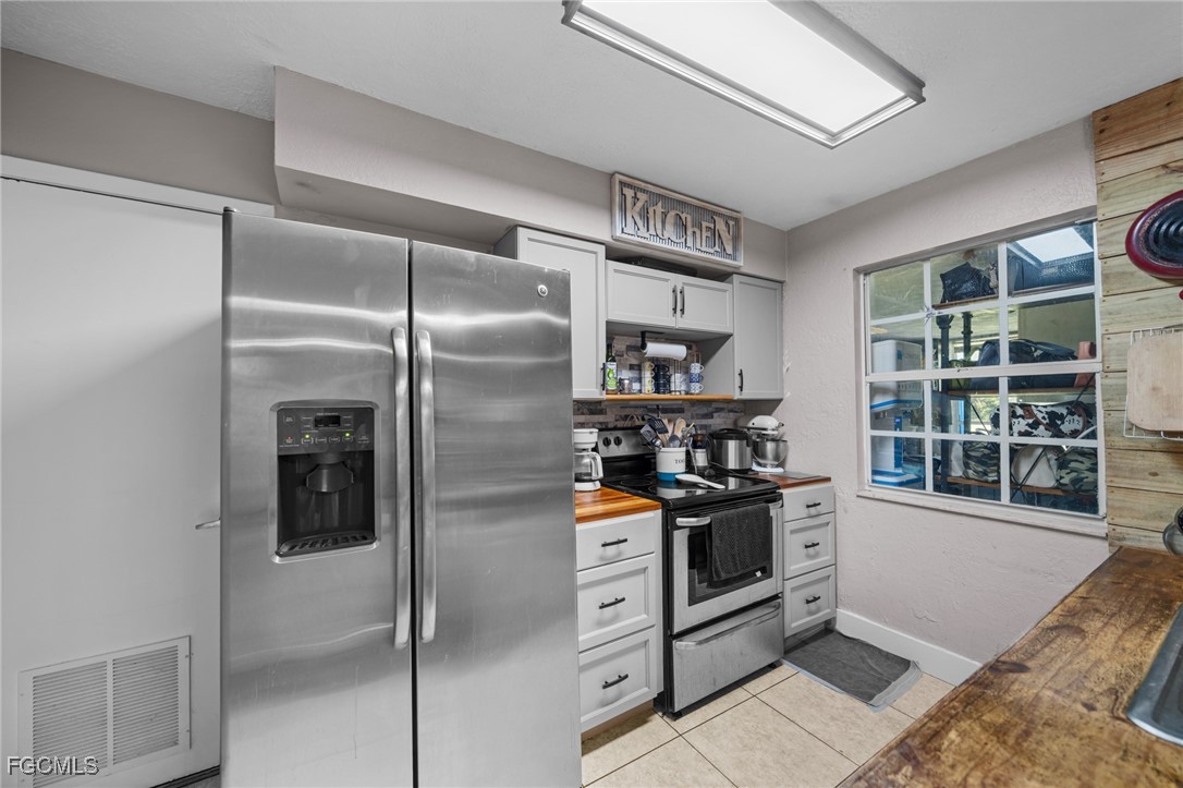 4121 16th Avenue Northeast Naples, FL 34120 - Photo 12 of 35 a kitchen with stainless steel appliances granite countertop a refrigerator and a sink