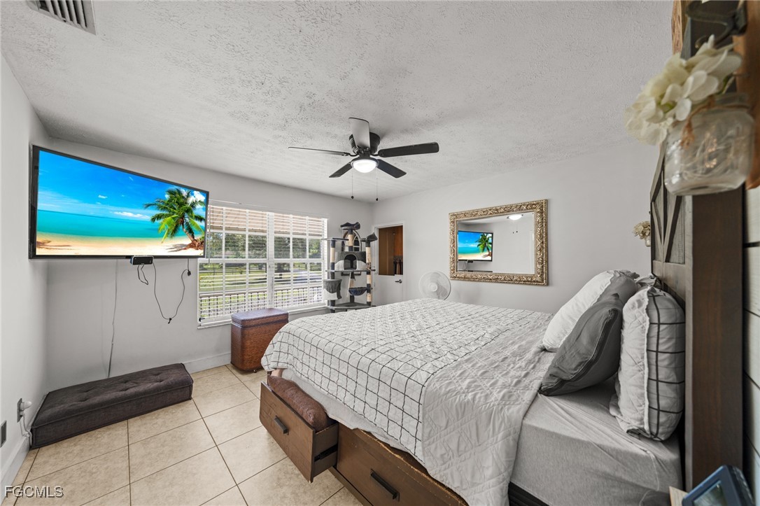 4121 16th Avenue Northeast Naples, FL 34120 - Photo 17 of 35 a bedroom with a bed and a ceiling fan