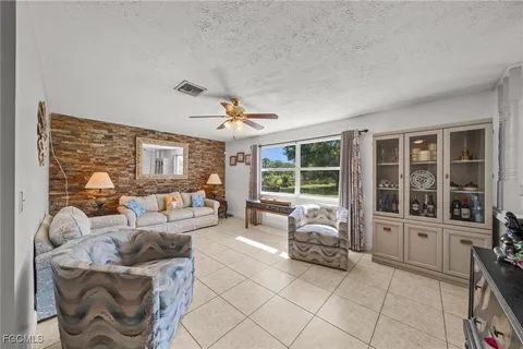 a living room with furniture and large windows
