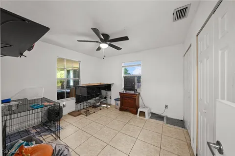 a living room with furniture a flat screen tv and a window