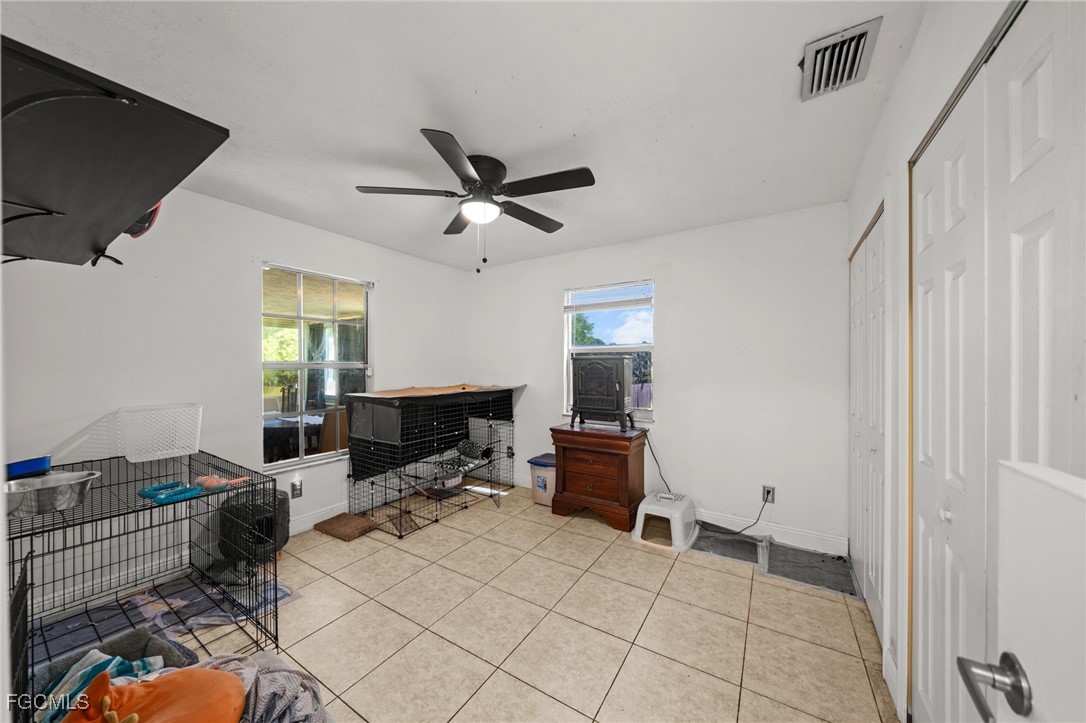 4121 16th Avenue Northeast Naples, FL 34120 - Photo 24 of 35 a living room with furniture a flat screen tv and a window