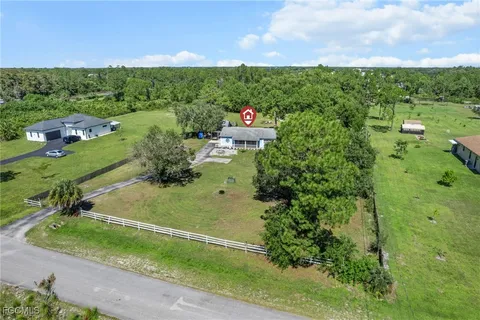 an aerial view of a house with a yard