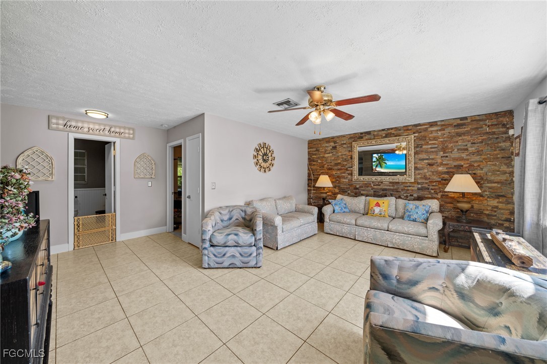 4121 16th Avenue Northeast Naples, FL 34120 - Photo 5 of 35 a living room with furniture and a flat screen tv