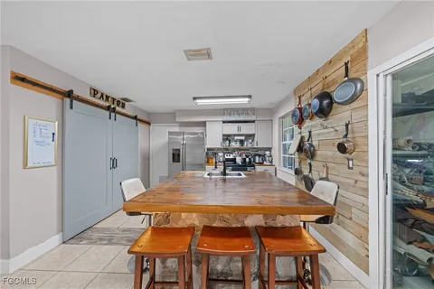 a dining room with a rug table and chairs