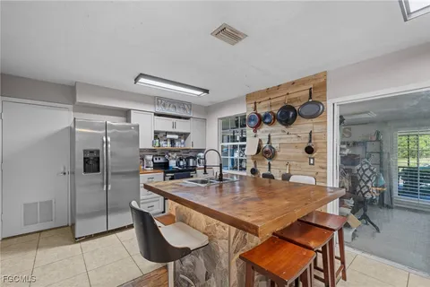 a kitchen with stainless steel appliances granite countertop a sink and a refrigerator