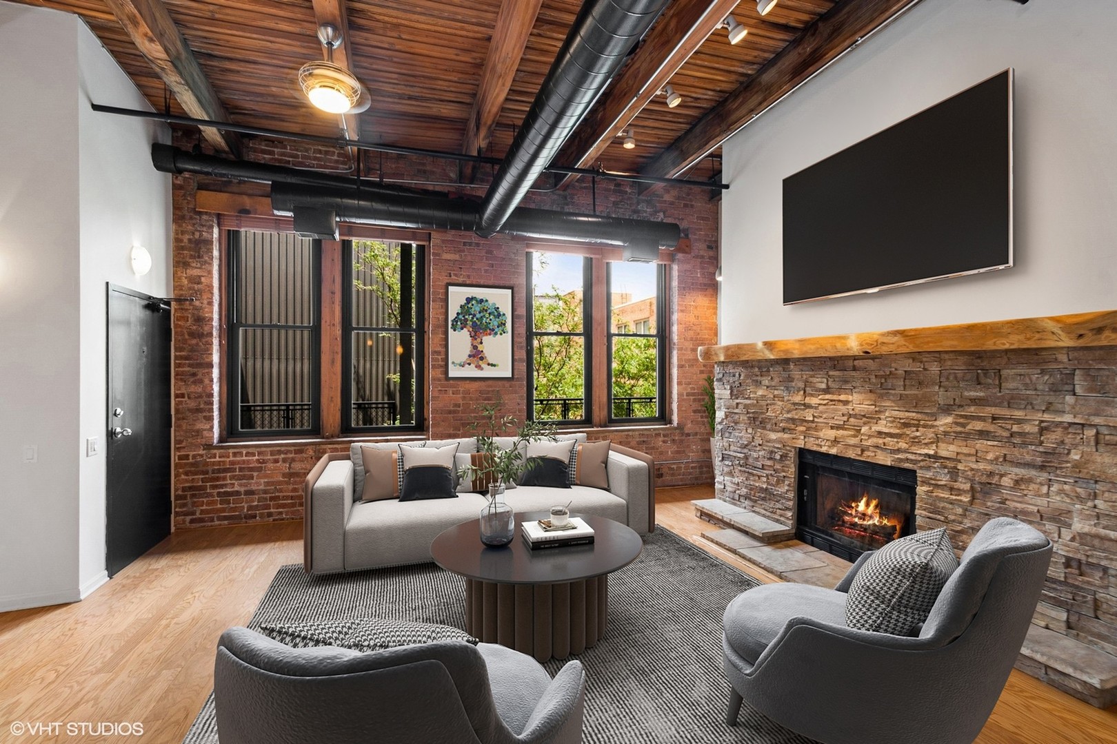 331 South Peoria Street, Unit PH6 Chicago, IL 60607 - Photo 6 of 46 a living room with furniture a fireplace and a flat screen tv