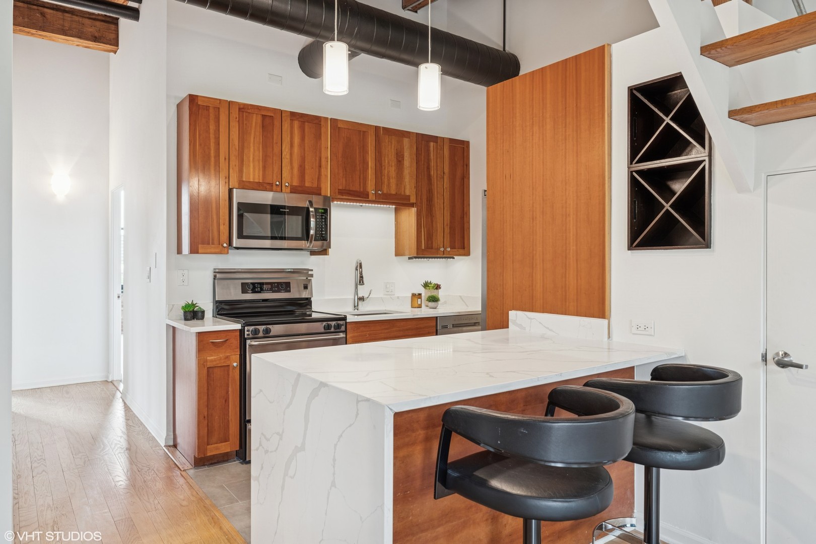 331 South Peoria Street, Unit PH6 Chicago, IL 60607 - Photo 10 of 46 a kitchen with stainless steel appliances a stove a microwave and a refrigerator