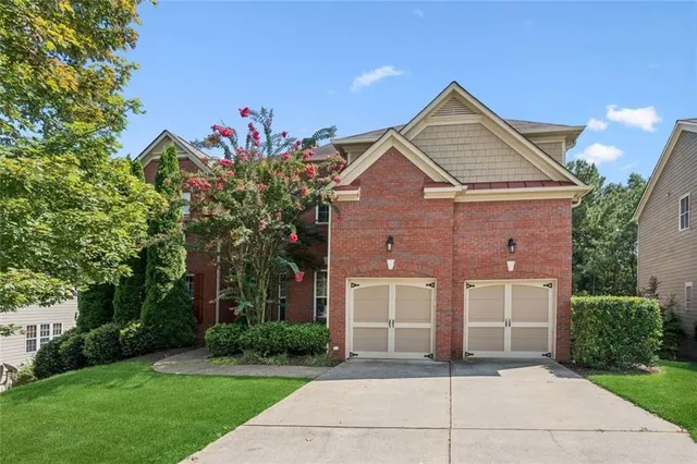 a front view of a house with a yard