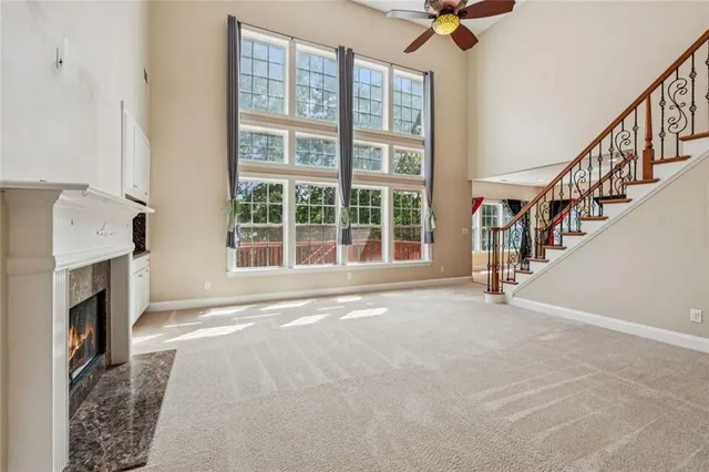 a view of an empty room with a fireplace and a window