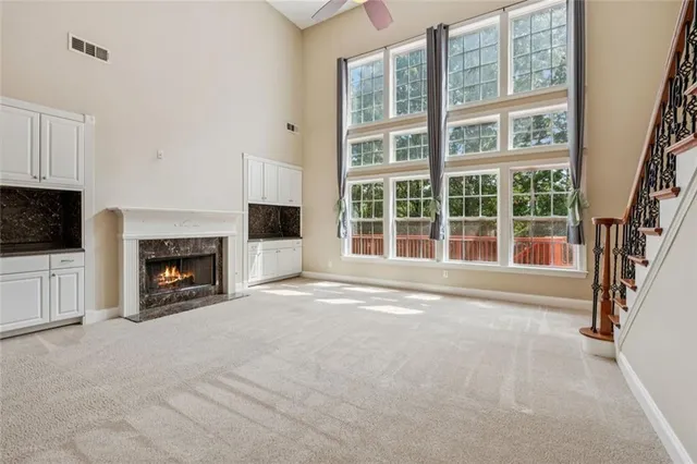 a view of a livingroom with an empty space and a fireplace