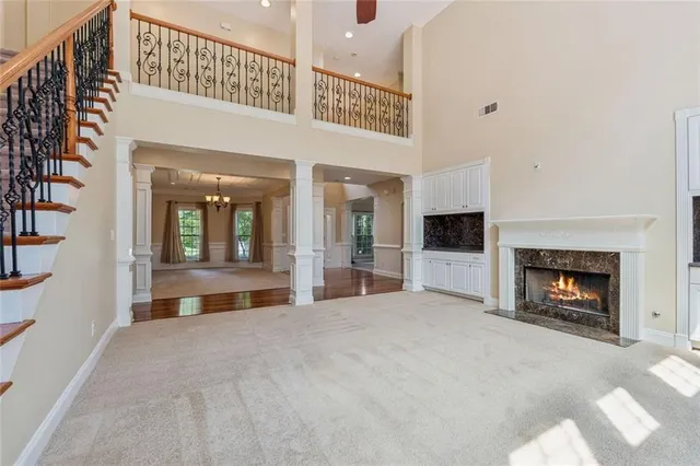 a view of an empty room with a fireplace and a window