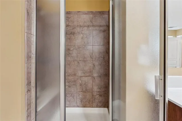 a bathroom with a glass shower door