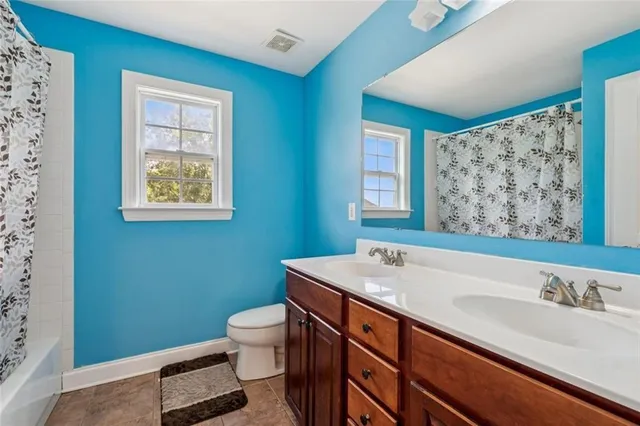 a bathroom with a shower a sink and a mirror