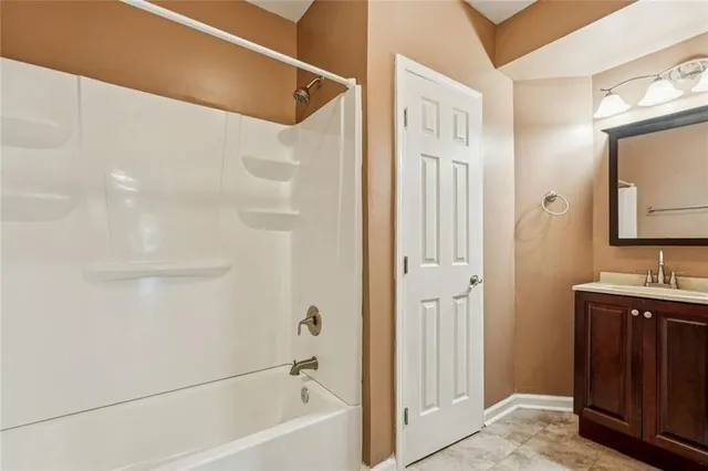 a bathroom with a granite countertop sink toilet a mirror and shower