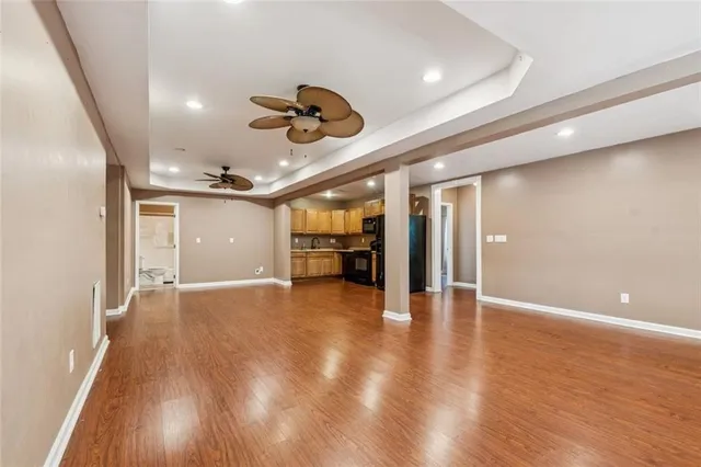 a view of an empty room with wooden floor