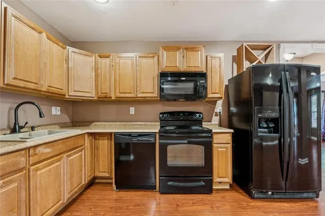 a view of a backyard with wooden fence and large windows