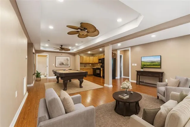 a living room with furniture and a wooden floor