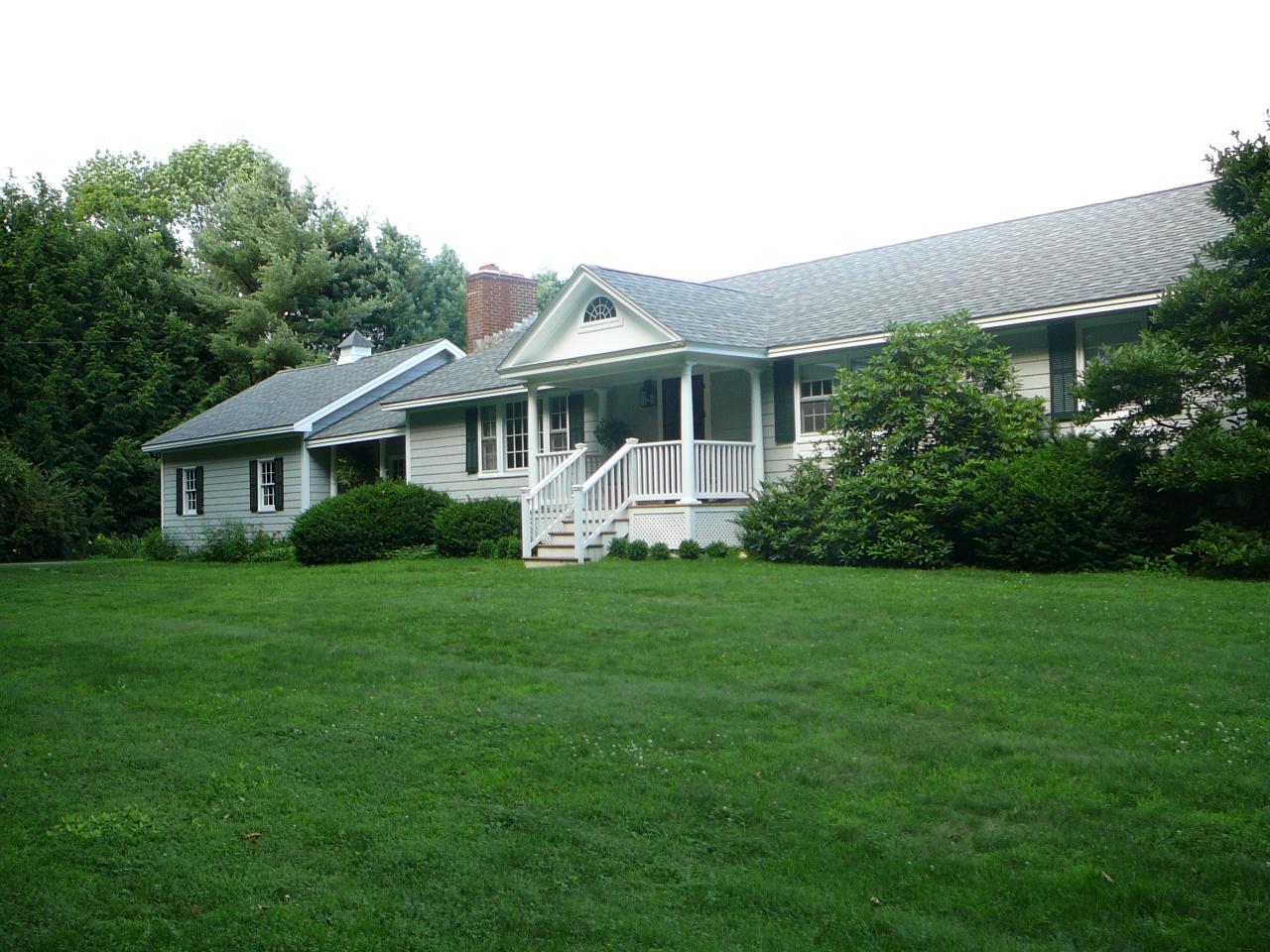 a front view of house with yard and green space