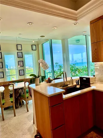 a kitchen with a sink and chairs