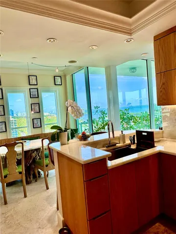 a kitchen with a sink and chairs