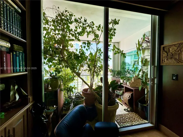 a living room filled with furniture and a potted plant