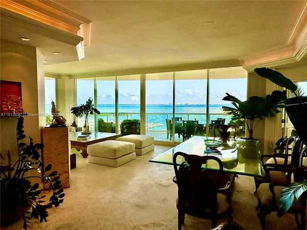 a living room with furniture and floor to ceiling window