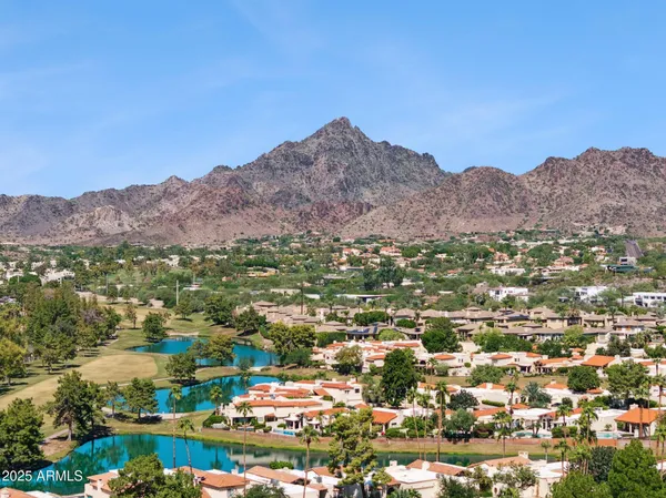 an aerial view of residential house and sandy dunes