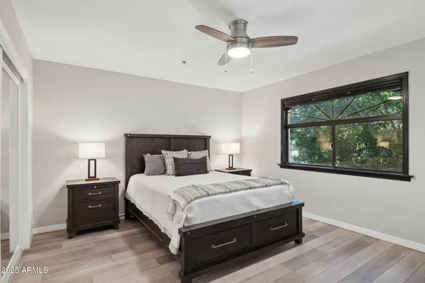 a bedroom with a bed lamp and window