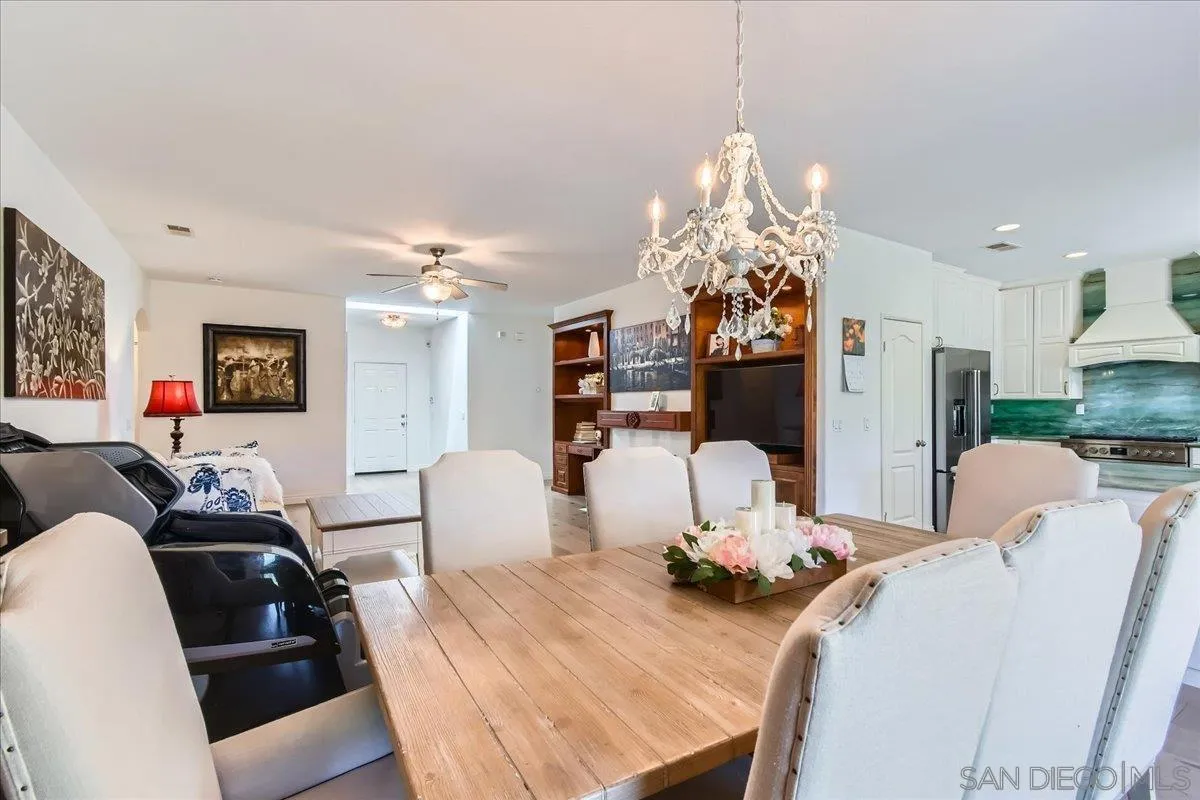 12709 Oak Knoll Road Poway, CA 92064 - Photo 11 of 36 a view of a dining room with furniture and chandelier