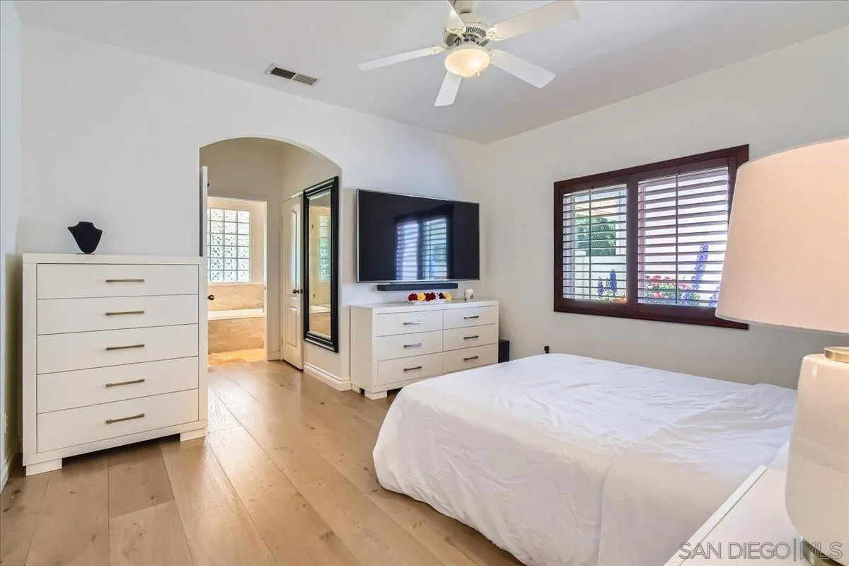 12709 Oak Knoll Road Poway, CA 92064 - Photo 17 of 36 a spacious bedroom with a bed and a dresser