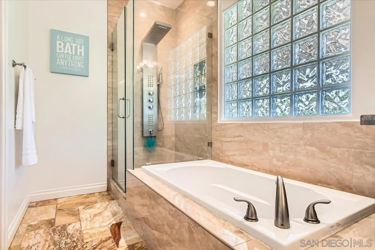12709 Oak Knoll Road Poway, CA 92064 - Photo 20 of 36 a bathroom with a bathtub and shower