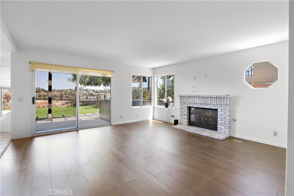 17316 Cold Spring Circle Riverside, CA 92503 - Photo 17 of 46 a view of an empty room with window and wooden floor