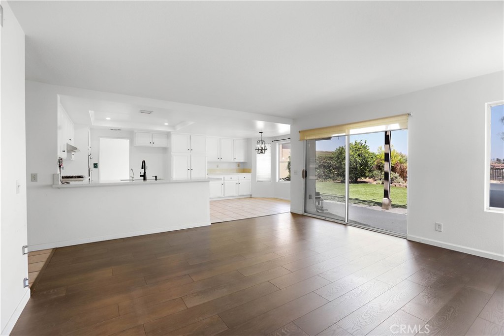 17316 Cold Spring Circle Riverside, CA 92503 - Photo 18 of 46 a view of an empty room with wooden floor and a window