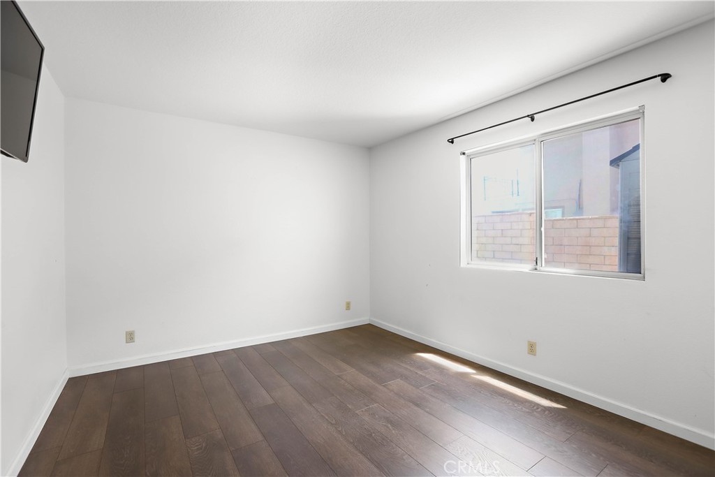 17316 Cold Spring Circle Riverside, CA 92503 - Photo 20 of 46 an empty room with wooden floor and windows
