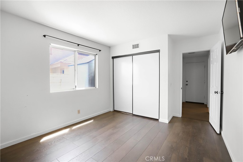 17316 Cold Spring Circle Riverside, CA 92503 - Photo 21 of 46 an empty room with wooden floor and a window
