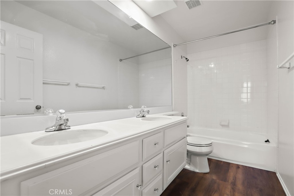 17316 Cold Spring Circle Riverside, CA 92503 - Photo 36 of 46 a bathroom with a double vanity sink a toilet and a bathtub