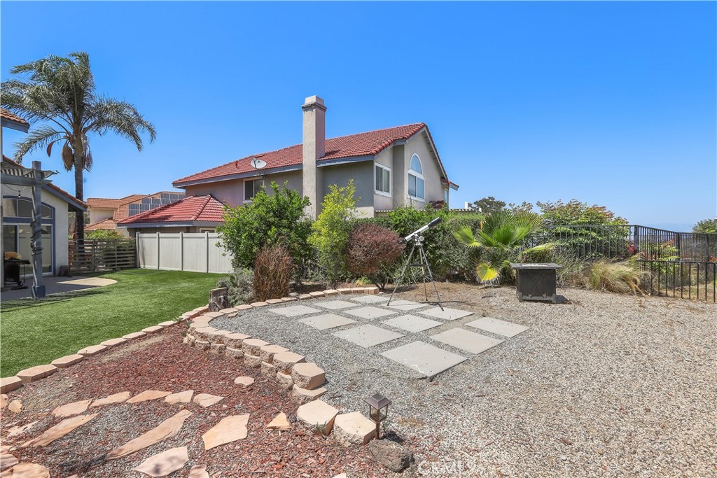 17316 Cold Spring Circle Riverside, CA 92503 - Photo 41 of 46 a front view of a house with a yard and potted plants