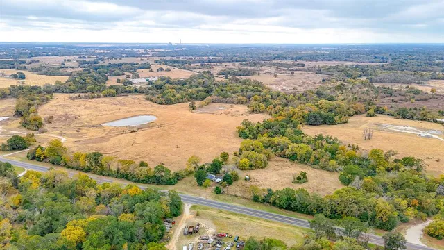 an aerial view of lake and residential houses with outdoor space