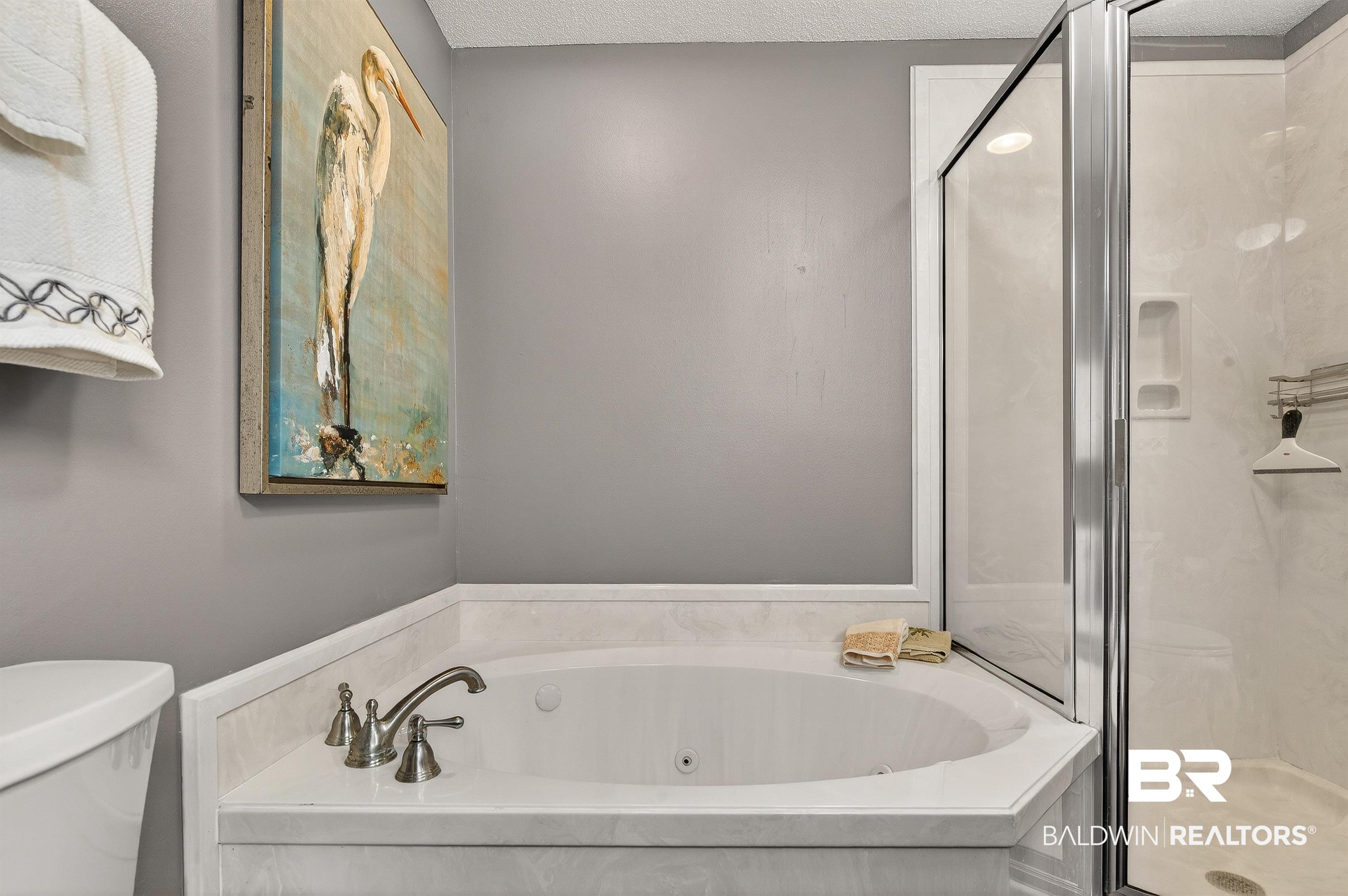 27582 Canal Road, Unit 2507 Orange Beach, AL 36561 - Photo 34 of 75 Full bathroom with a whirlpool tub, a marble finish shower, and a textured ceiling