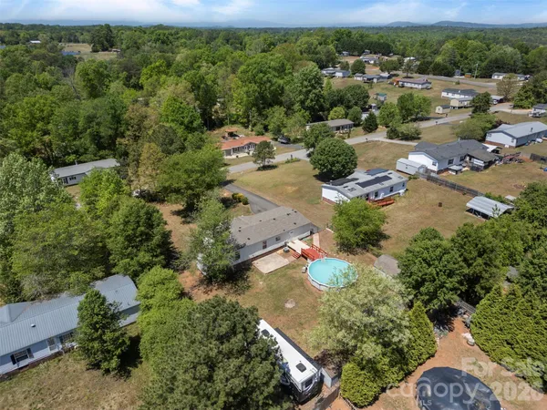 an aerial view of a houses with a yard