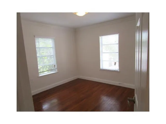 a room with a window and a wooden floor