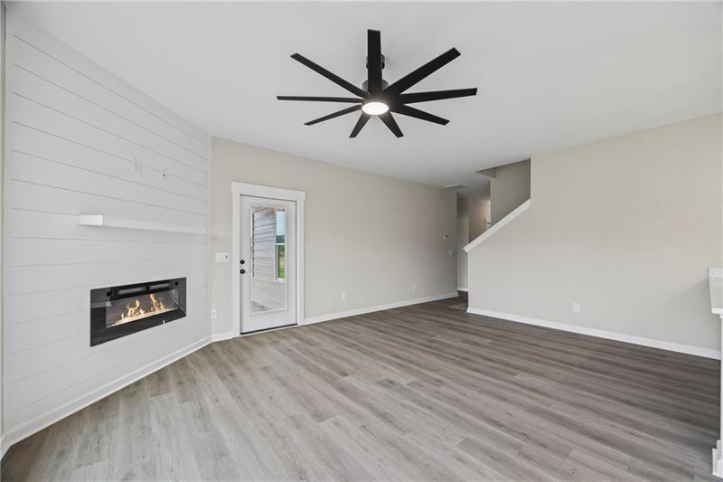 693 Racetrack Road Toccoa, GA 30577 - Photo 11 of 45 a view of empty room with wooden floor and ceiling fan
