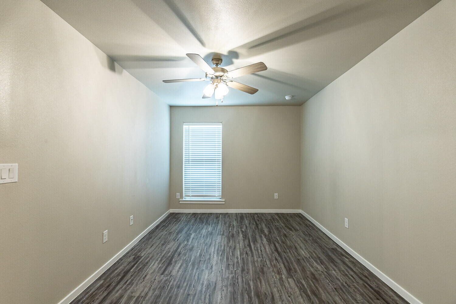 1901 Langford Avenue, Unit B Lubbock, TX 79407 - Photo 8 of 11 wooden floor in an empty room with a window