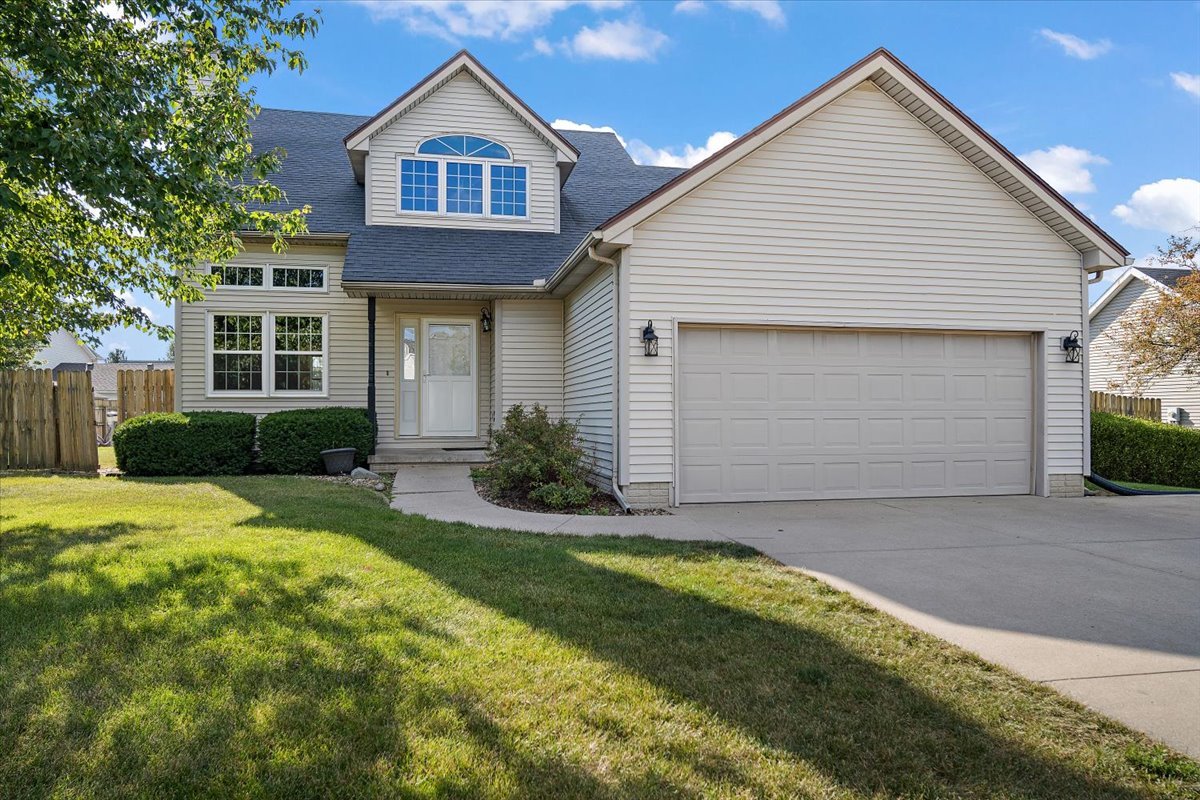 606 Windward Way Heyworth, IL 61745 - Photo 1 of 30 a front view of a house with a yard and garage
